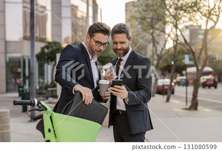 Businessmen in suit with phone. Online working. Businessmen checking business chat. Business men freelancing outdoor. Business online. Men working on phone. Businessmen working online. Check email 131080599