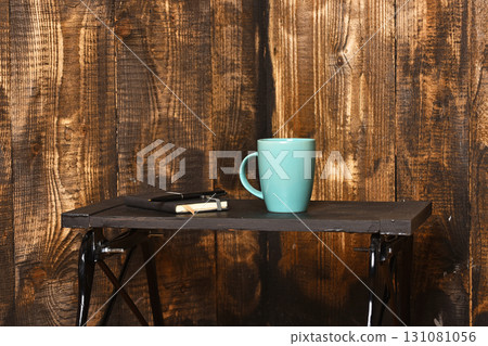 tea or coffee cup for drink with copybook and pen 131081056