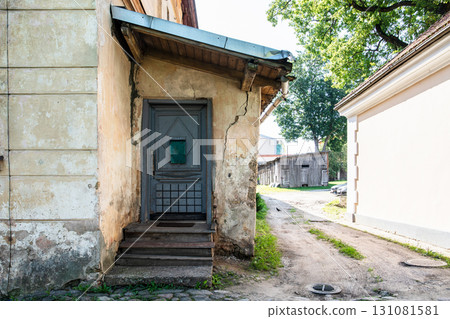 Old Weathered Wooden Door Entrance with Small Canopy 131081581