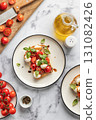 Caprese sandwich or toast with mozzarrella balls, cherry tomatoes, olive oil and fresh basil leaves top view. Healthy vegetarian breakfast, snack or lunch. White marble background 131082426