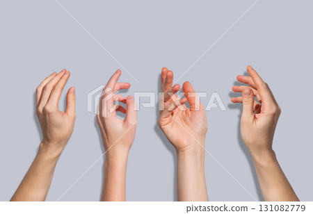 Four human hands in expressive gesture poses on a gray background. Concept of communication Four human hands in expressive gesture poses on a gray background. Concept of communication 131082779