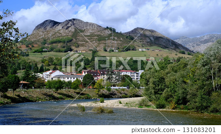 A scenic view of a river flowing through a small town, Arriondas in Asturias, Spain. 131083201