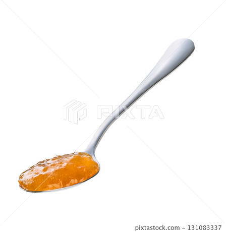 Spoon with organic orange  jam isolated on a white background. 131083337
