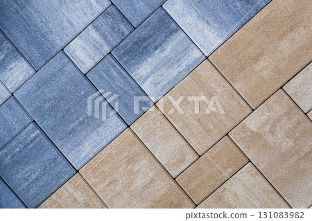 Two tone paving stones in blue gray and brown shades forming striking pattern. Concept of paving stones, pavement design, decorative outdoor flooring. Geometric diagonal background Two tone paving stones in blue gray and brown shades forming striking pattern. Concept of paving stones, pavement design, decorative outdoor flooring. Geometric diagonal background 131083982