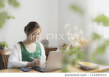 A woman using a computer 131084414