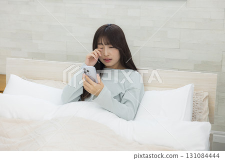 Tired woman in bed Tired woman in bed 131084444