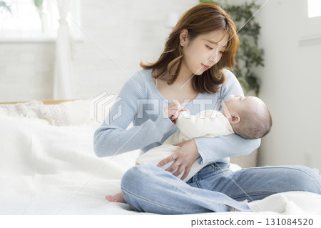 Young mother holding her baby Young mother holding her baby 131084520
