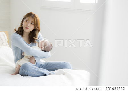 Young mother holding her baby Young mother holding her baby 131084522