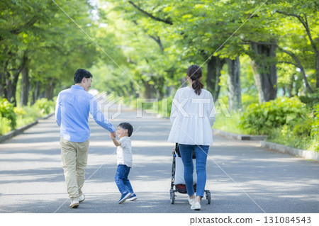 Family walking in the fresh green park 131084543