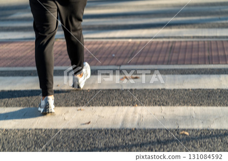 Walking on a Crosswalk During a Sunny Day in an Walking on a Crosswalk During a Sunny Day in an 131084592