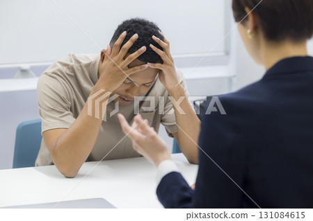 A woman explaining to a foreign man A woman explaining to a foreign man 131084615