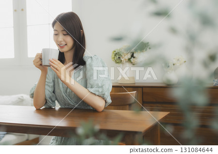 A woman drinking coffee A woman drinking coffee 131084644