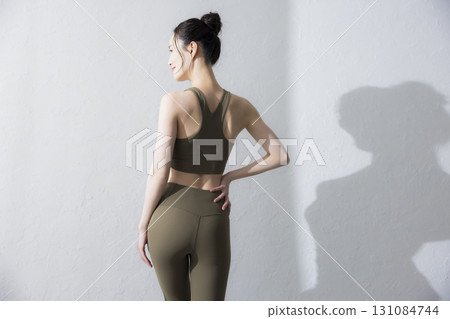 A woman stretching in training wear A woman stretching in training wear 131084744