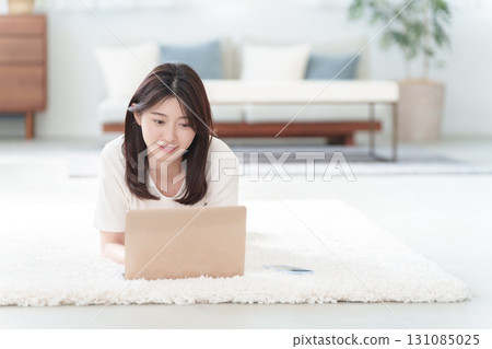 Young woman using a personal computer Young woman using a personal computer 131085025