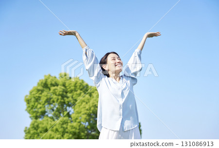 Woman taking a deep breath outdoors 131086913