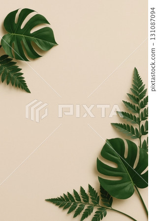 Green tropical leaves arranged on beige background with copy space Green tropical leaves arranged on beige background with copy space 131087094