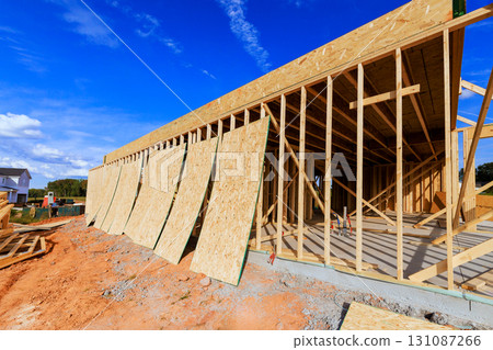 Wooden frames plywood board are being installed on house under construction with beams frame 131087266