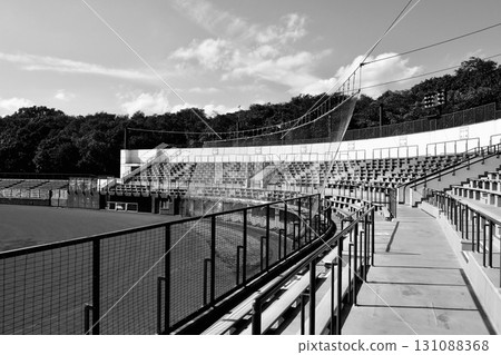 Sunny baseball stadium "spectator seats behind the backstop" black and white Sunny baseball stadium "spectator seats behind the backstop" black and white 131088368