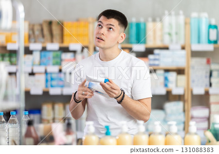 Guy buys gel for burns at pharmacy Guy buys gel for burns at pharmacy 131088383