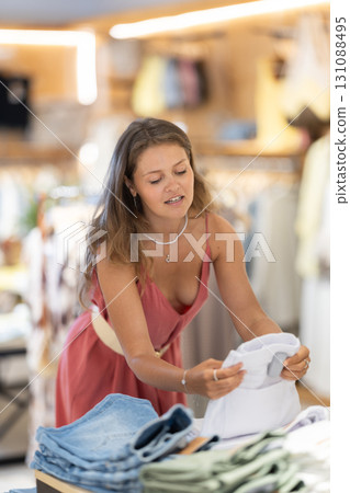 Girl customer chooses shorts in store 131088495