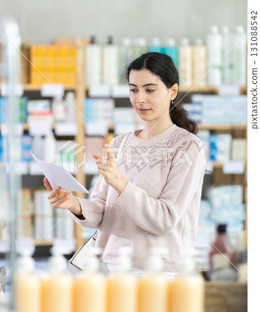 Woman with medical prescription in pharmacy Woman with medical prescription in pharmacy 131088542