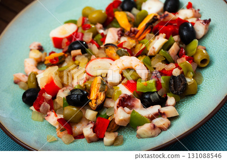 Delicious salad from variety of seafood with chopped vegetables (Salpicon de mariscos) typical for Spanish cuisine Delicious salad from variety of seafood with chopped vegetables (Salpicon de mariscos) typical for Spanish cuisine 131088546