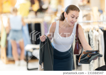 Woman shopping in a boutique Woman shopping in a boutique 131088547