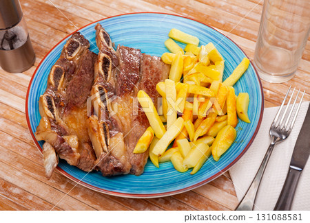 Churrasco veal ribs with side dish of french fries 131088581