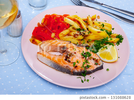 Portion of salmon steak with red pepper and fried potato Portion of salmon steak with red pepper and fried potato 131088628