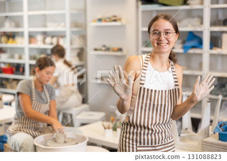 Teenage girl posing in ceramic workshop Teenage girl posing in ceramic workshop 131088823