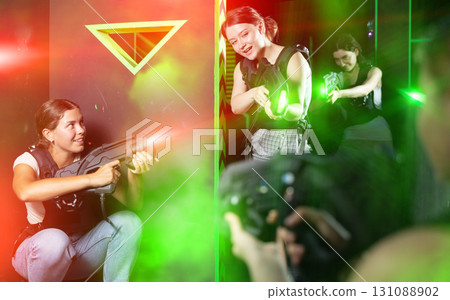 Girls play laser tag, jokingly fight with light weapons Girls play laser tag, jokingly fight with light weapons 131088902