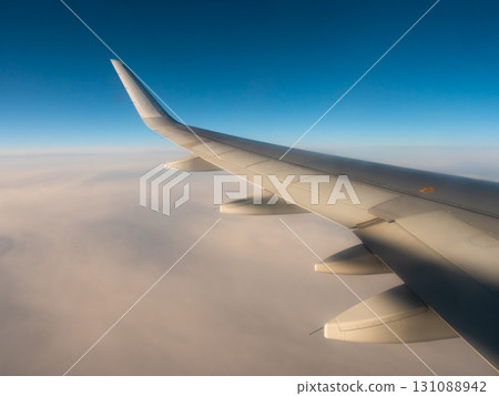 Airplane wing. view from the airplanes porthole Airplane wing. view from the airplanes porthole 131088942