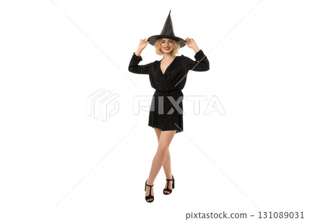 Woman in black dress enjoys Halloween fun, isolated on white, PNG 131089031