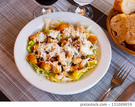 Just cooked Caesar salad served on white plate 131089059