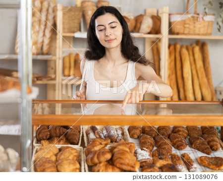 Young woman choosing pastries in bakery Young woman choosing pastries in bakery 131089076