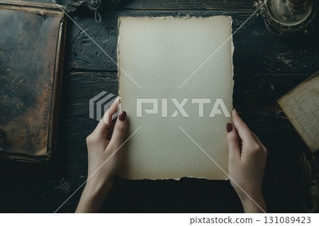 A woman holds a blank piece of paper in her hands A woman holds a blank piece of paper in her hands 131089423