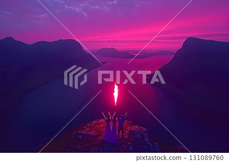 Couple Celebrates Sunset with Flare on Mountaintop Couple Celebrates Sunset with Flare on Mountaintop 131089760