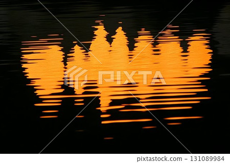 Fiery Sunset Reflection Distorted on Rippled Water Fiery Sunset Reflection Distorted on Rippled Water 131089984