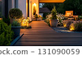 Evening Lit Wooden Deck with Lush Plants and Warm Ambient Lighti 131090059
