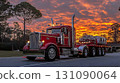 Crimson Peterbilt Truck Silhouetted Against a Fiery Sunset Sky o 131090064