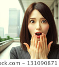 Surprised young woman with her hand on her mouth 131090871