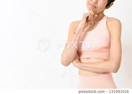 A middle-aged woman in sportswear who is worried A middle-aged woman in sportswear who is worried 131091016