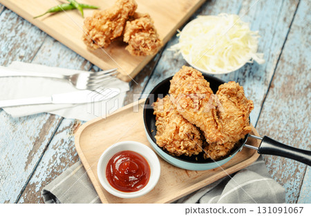 Crispy Fried chicken with tomato sauce on grunge background table. Fast food unhealthy. 131091067