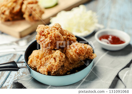 Crispy Fried chicken with tomato sauce on grunge background table. Fast food unhealthy. Crispy Fried chicken with tomato sauce on grunge background table. Fast food unhealthy. 131091068