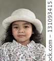 Portrait of Asian little girl with white hat on gray background. Portrait of Asian little girl with white hat on gray background. 131093415