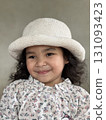 Portrait of a cute little girl in a white hat smiling. Portrait of a cute little girl in a white hat smiling. 131093423