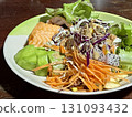 Salad with salmon and vegetables in a plate on a wooden table Salad with salmon and vegetables in a plate on a wooden table 131093432