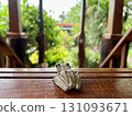 Wooden table with tree frog on nature background. Selective focus. Wooden table with tree frog on nature background. Selective focus. 131093671