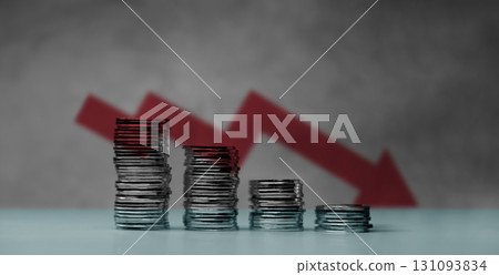 Downward red arrow with shrinking stacks of coins, depicting global recession, economic downturn, and significant financial loss. Downward red arrow with shrinking stacks of coins, depicting global recession, economic downturn, and significant financial loss. 131093834