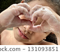 Close-up of Asian little girl playing with soap foam on her face Close-up of Asian little girl playing with soap foam on her face 131093851